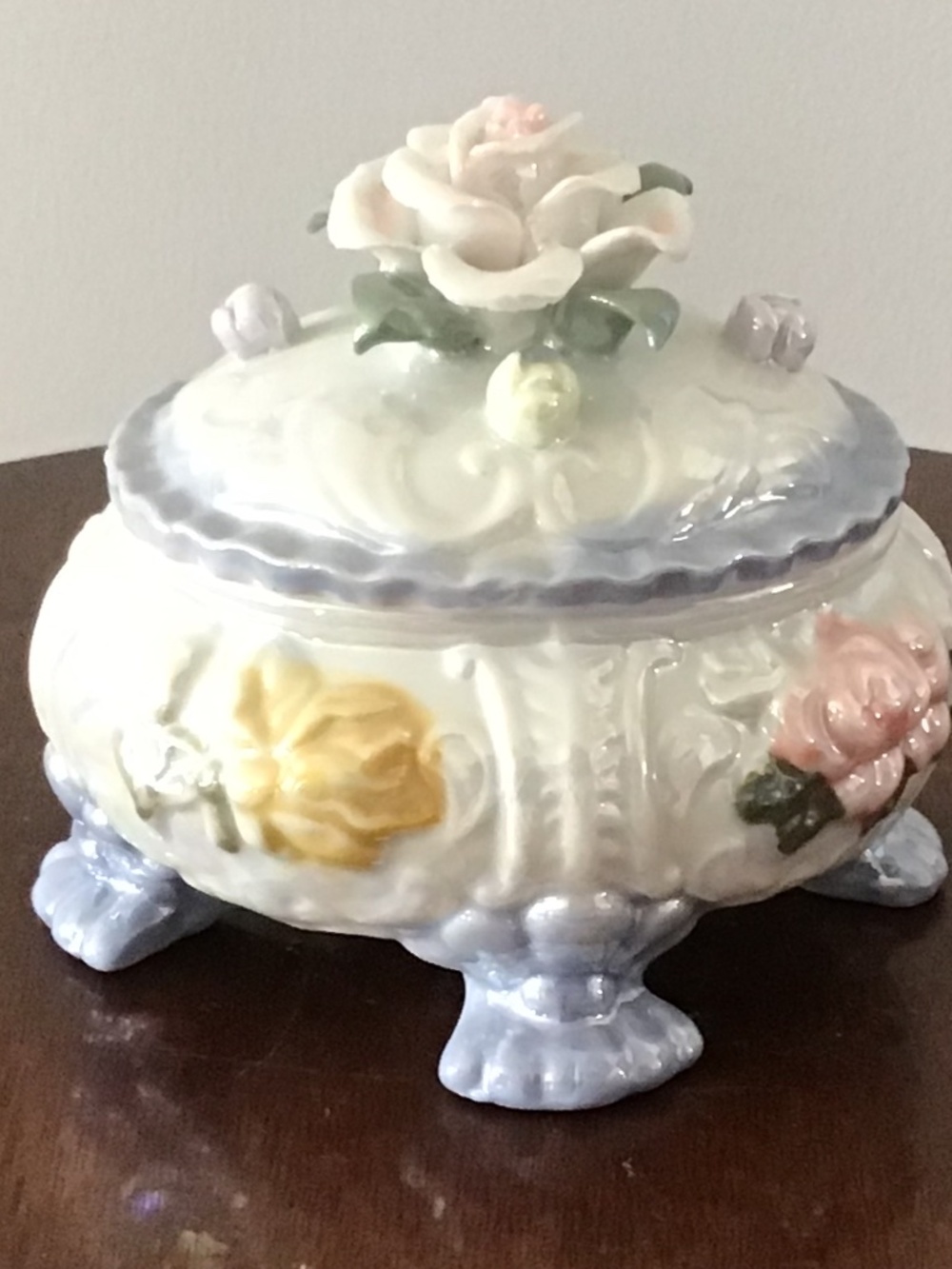 Vintage iridescent porcelain footed trinket box with applied floral decorations